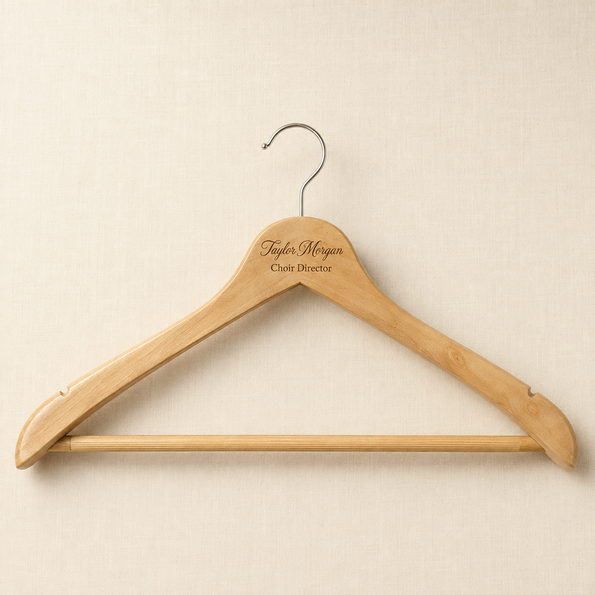 Personalized natural wood hanger engraved with a custom name and title